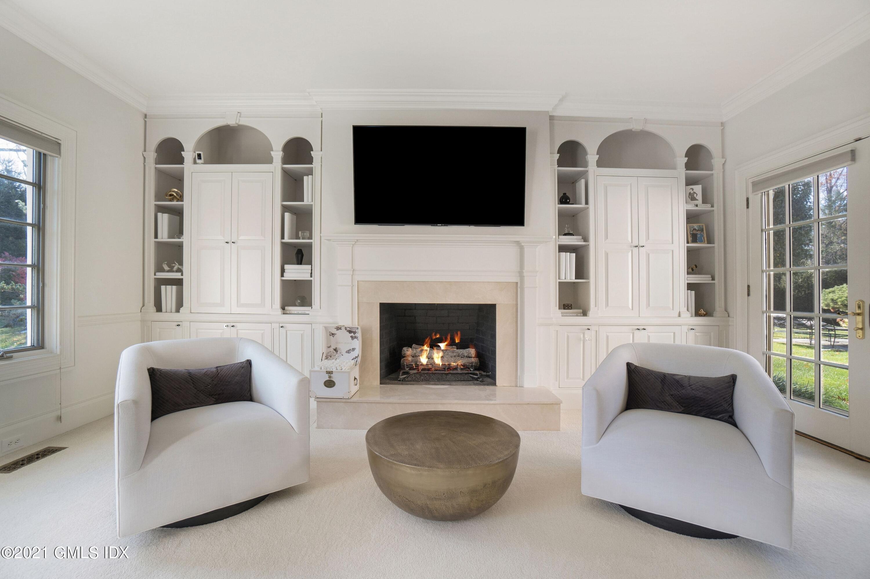 60 Round Hill Road Greenwich, CT 06831 - Photo 24 of 34 a living room with furniture a flat screen tv and a fireplace