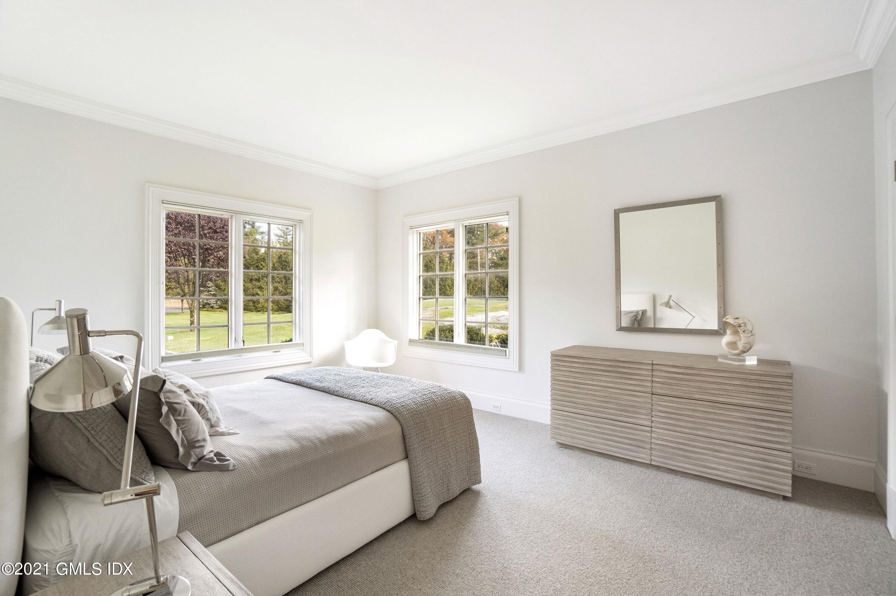 60 Round Hill Road Greenwich, CT 06831 - Photo 28 of 34 a bedroom with a bed and a window