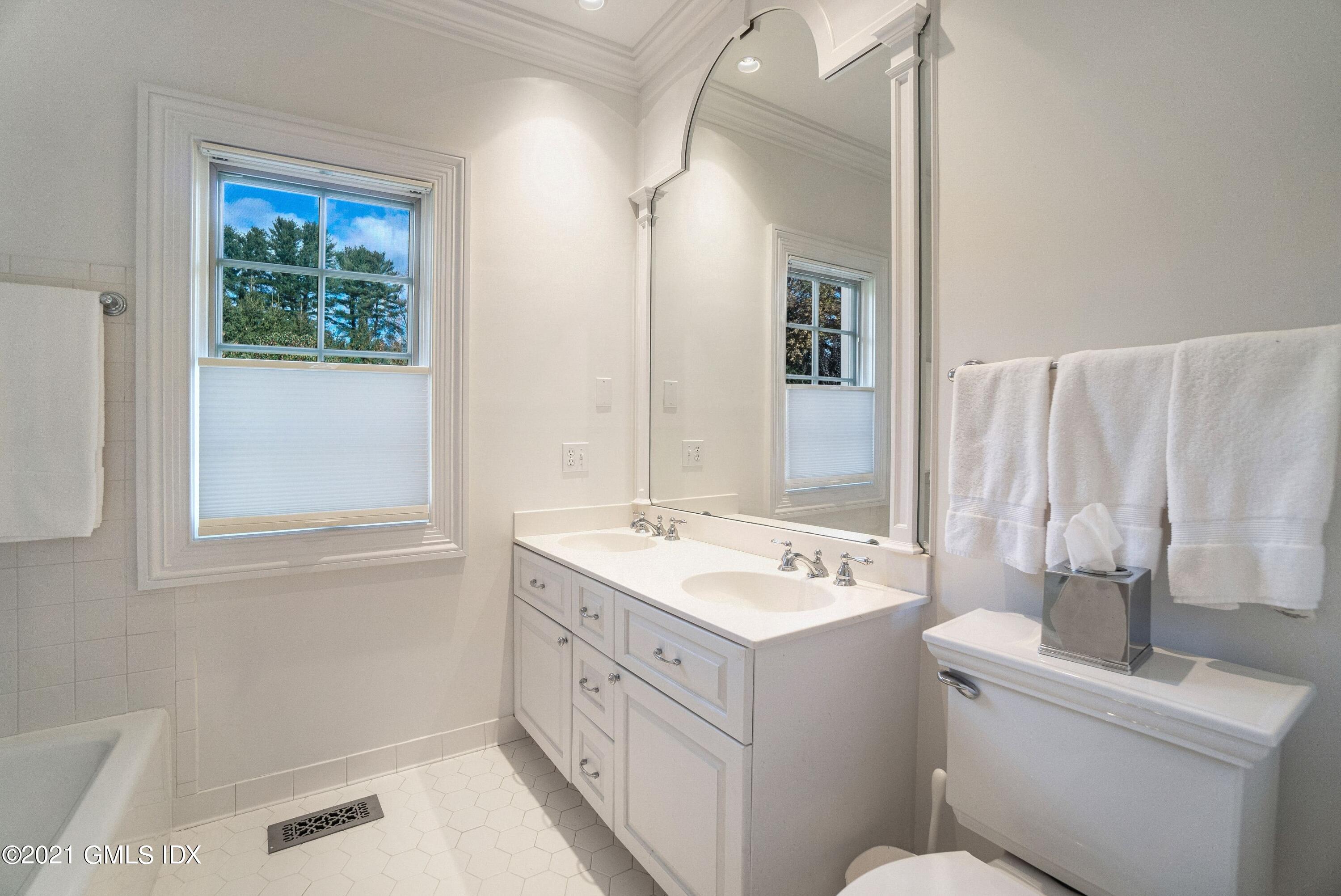 60 Round Hill Road Greenwich, CT 06831 - Photo 30 of 34 a bathroom with a sink a toilet and a mirror