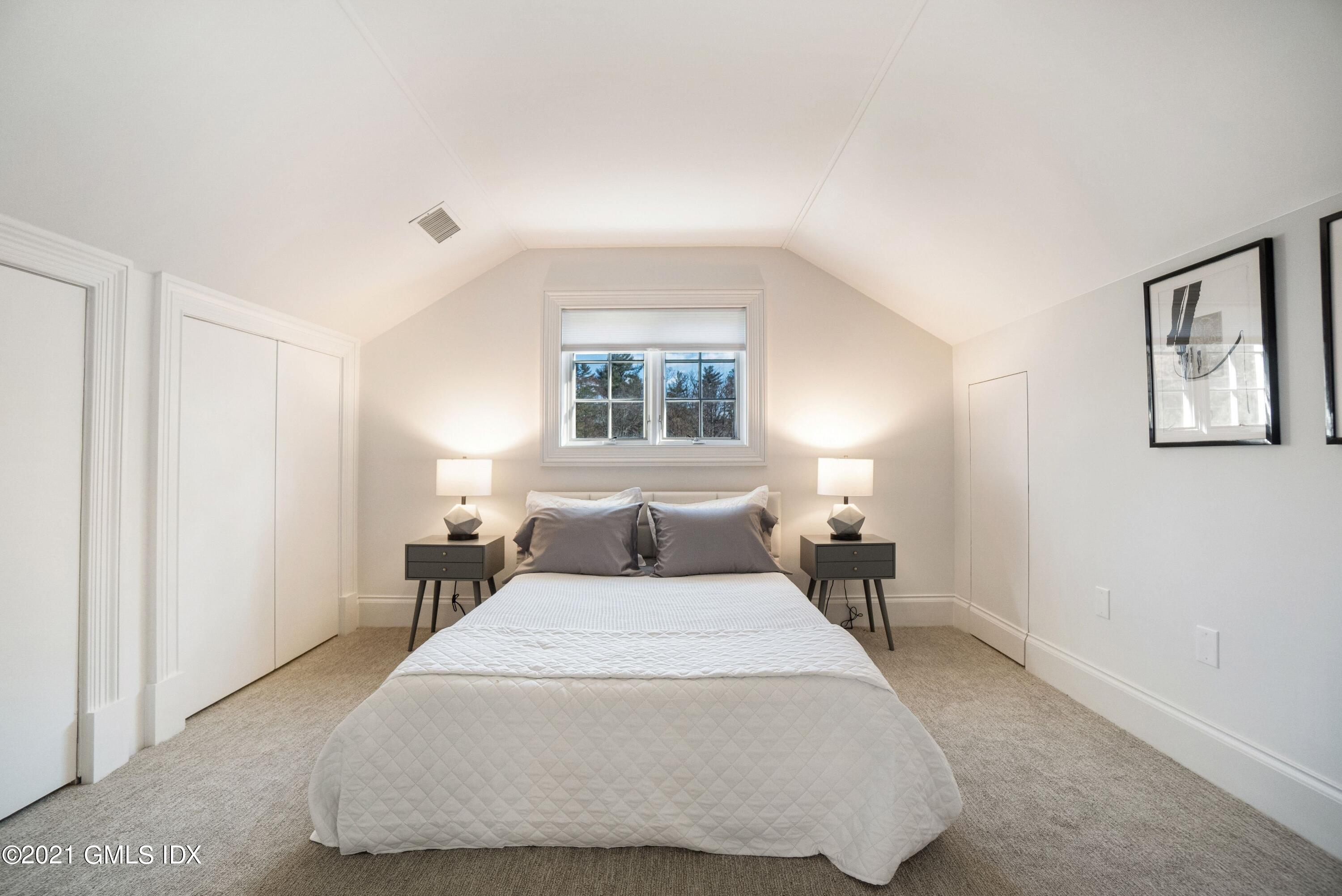 60 Round Hill Road Greenwich, CT 06831 - Photo 31 of 34 a bedroom with a bed and lamp