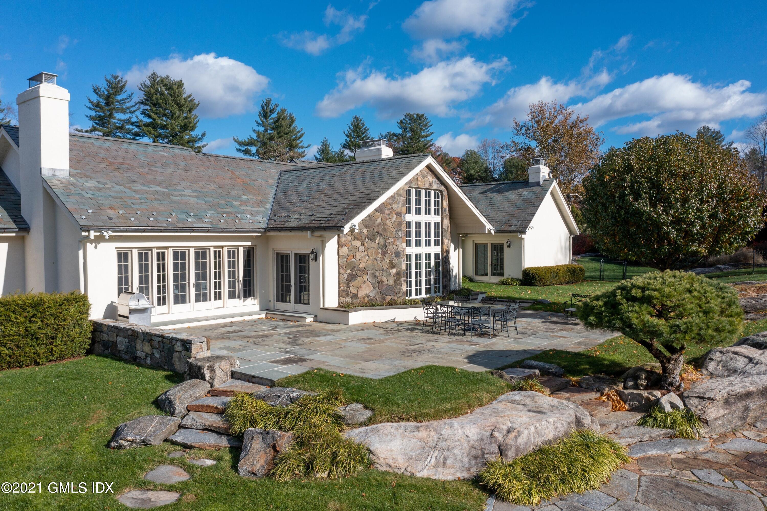 60 Round Hill Road Greenwich, CT 06831 - Photo 4 of 34 a view of a house with a yard