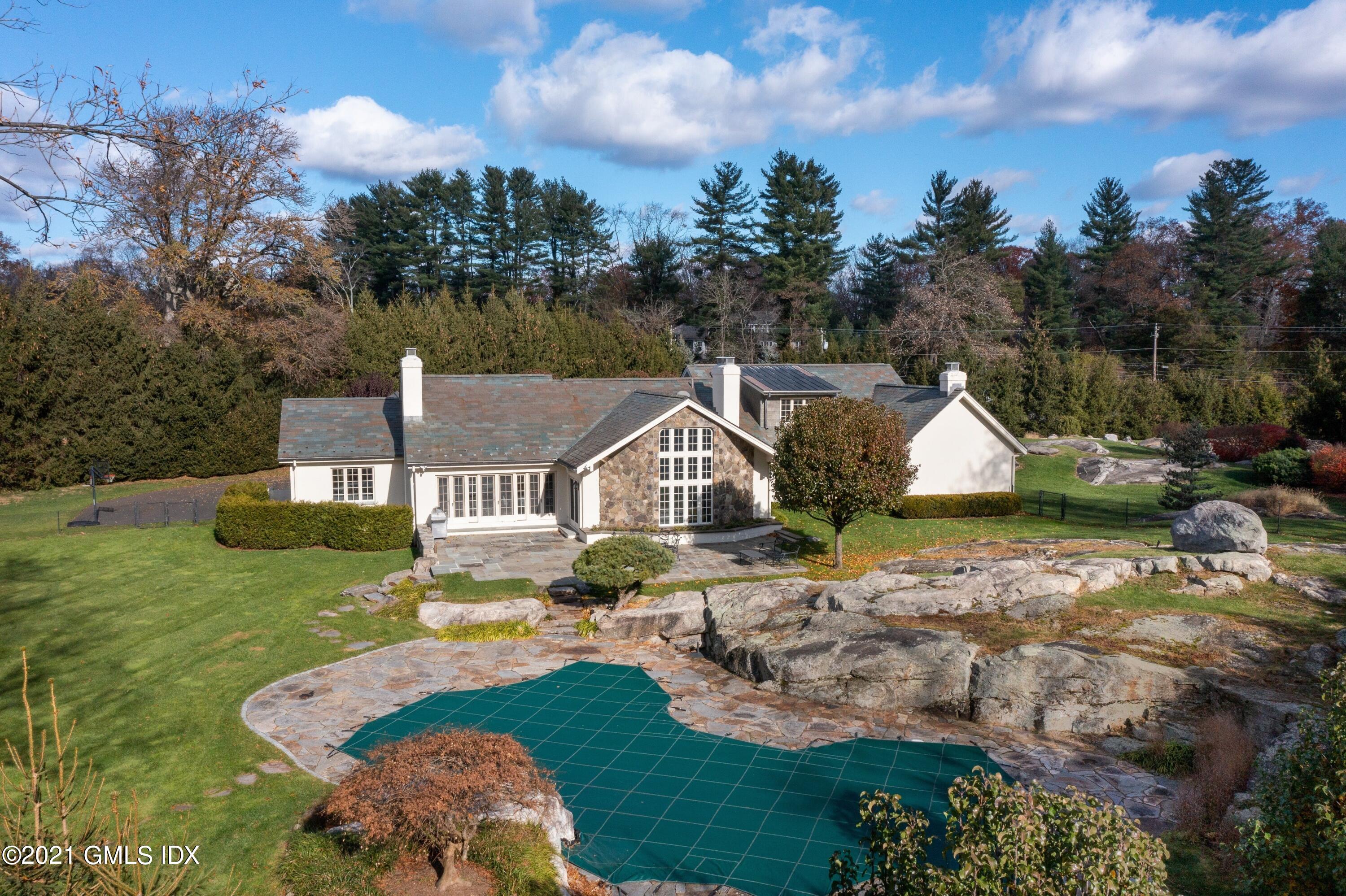 60 Round Hill Road Greenwich, CT 06831 - Photo 5 of 34 a aerial view of a house with swimming pool and a yard