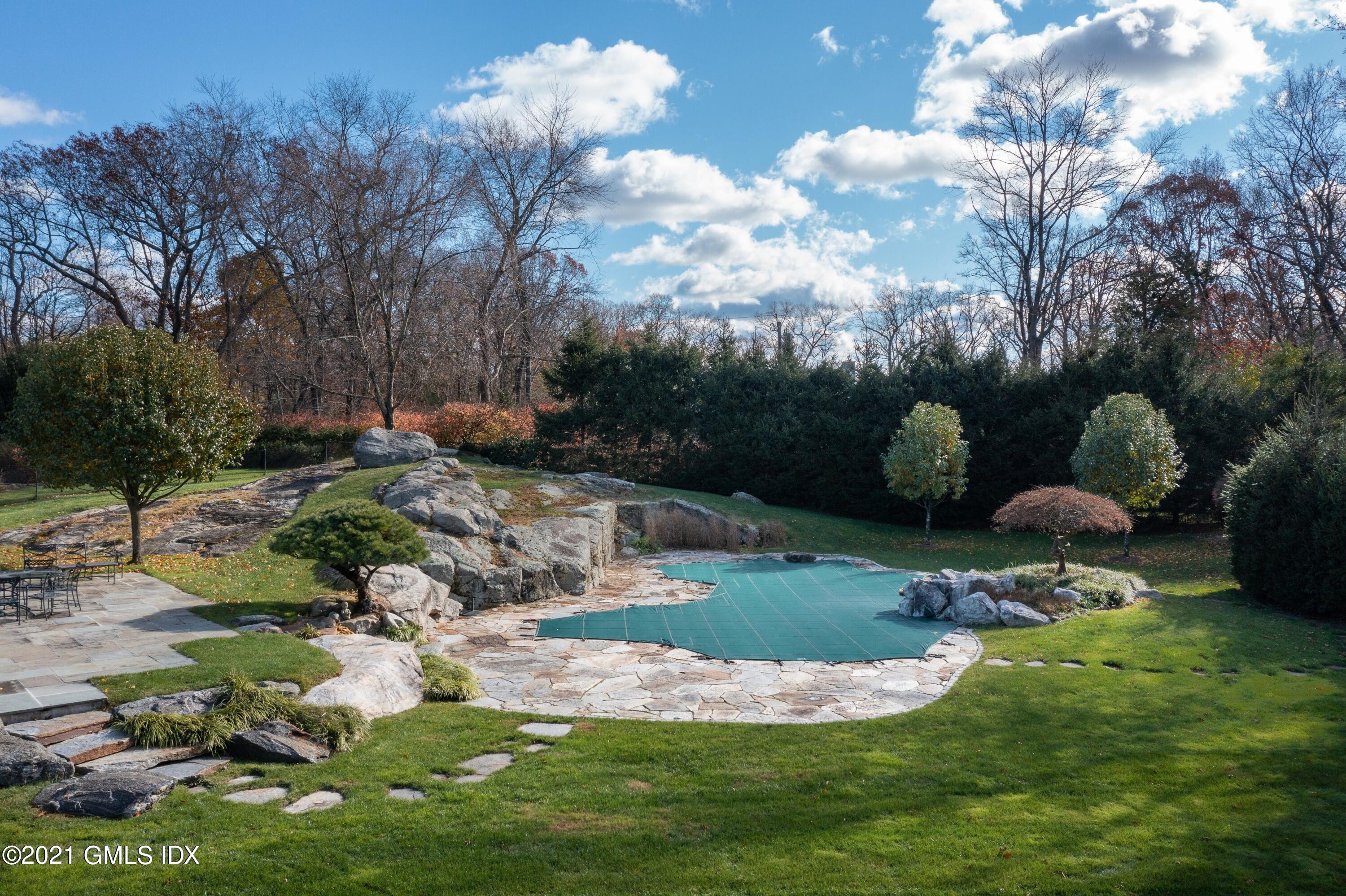 60 Round Hill Road Greenwich, CT 06831 - Photo 9 of 34 a backyard of a house with lots of green space