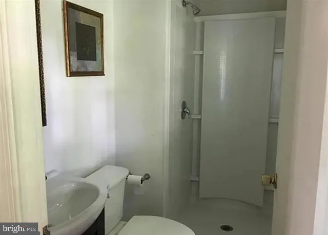 a bathroom with a toilet and a shower