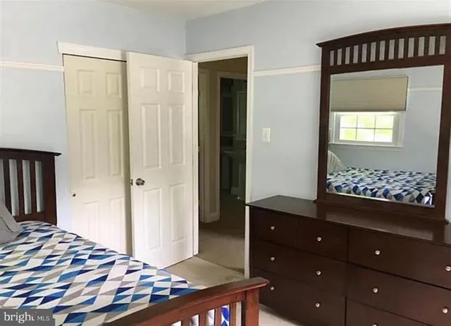 a bedroom with a bed and a dresser