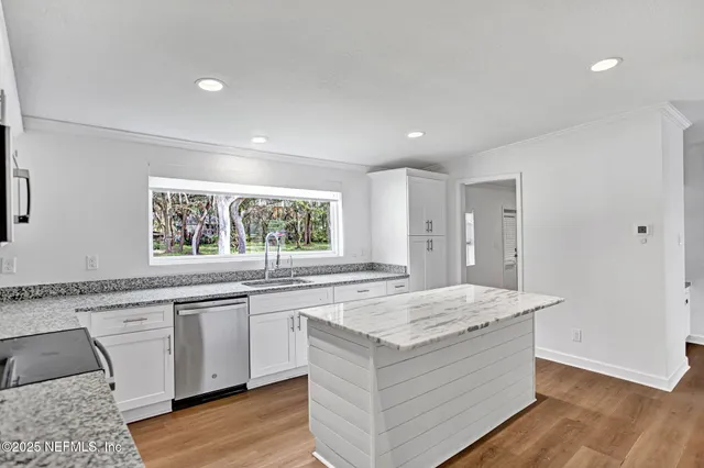 a kitchen with stainless steel appliances a refrigerator and a stove