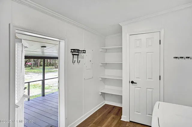 a view of a hallway with wooden floor and closet
