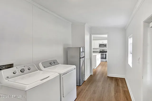 a view of a deck with wooden floor and garden view