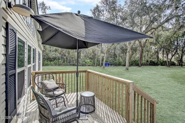 a view of a chair and table on the deck