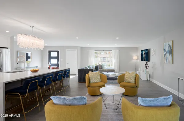 a living room with furniture a rug and a table