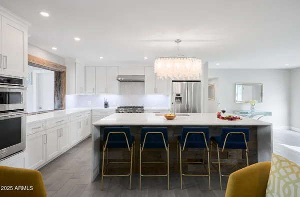 a kitchen with a table chairs sink and cabinets