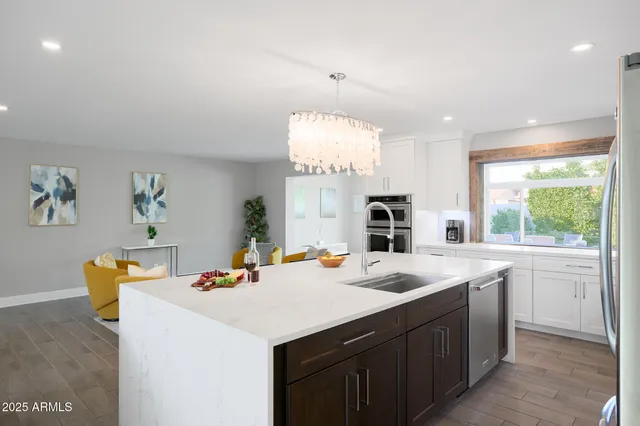 a kitchen that has a sink and a stove in it