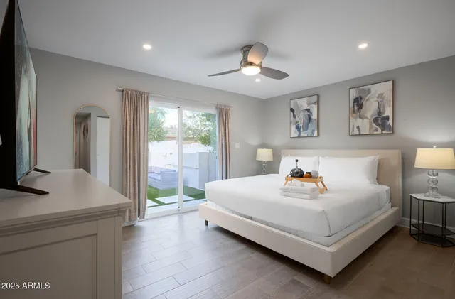 a bedroom with a bed and a large window