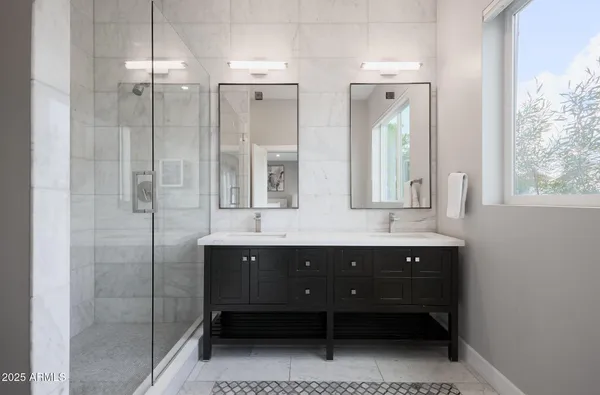 a bathroom with a double vanity sink mirror and double