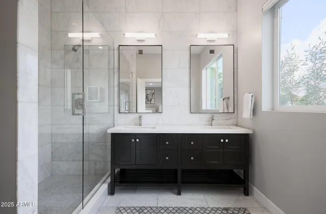 a bathroom with a double vanity sink mirror and double