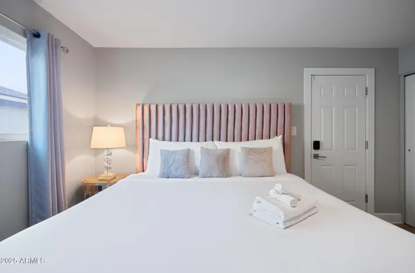 a bedroom with a bed and a lamp