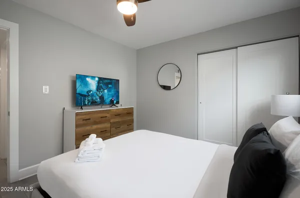 a bedroom with a bed and a flat screen tv