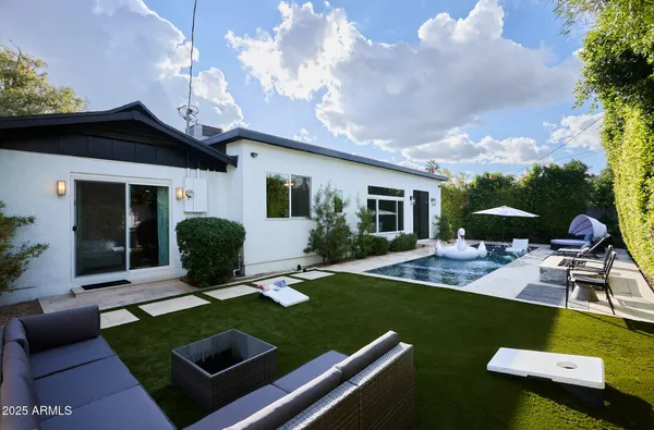 a view of a house with backyard sitting area and garden