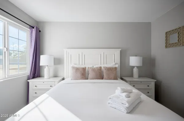 a bedroom with a bed and a window