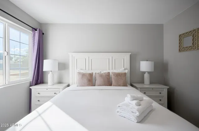 a bedroom with a bed and a window