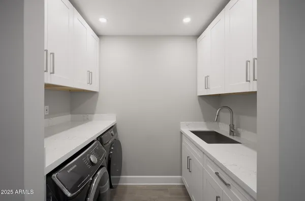a kitchen with stainless steel appliances granite countertop a sink and a stove