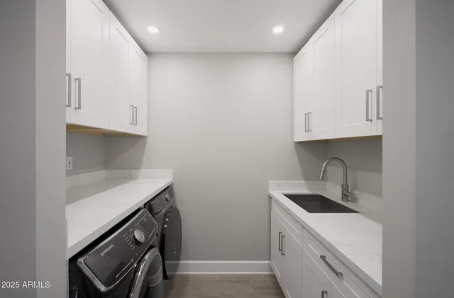 a kitchen with stainless steel appliances granite countertop a sink and a stove