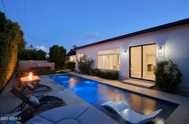 a swimming pool with outdoor seating