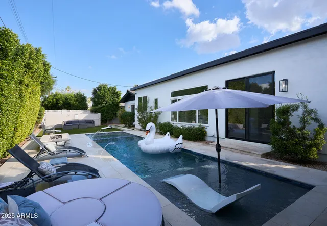 a view of patio with couches and potted plants