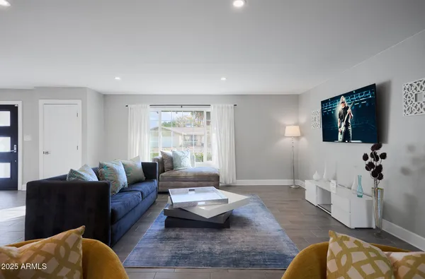 a living room with furniture and a flat screen tv