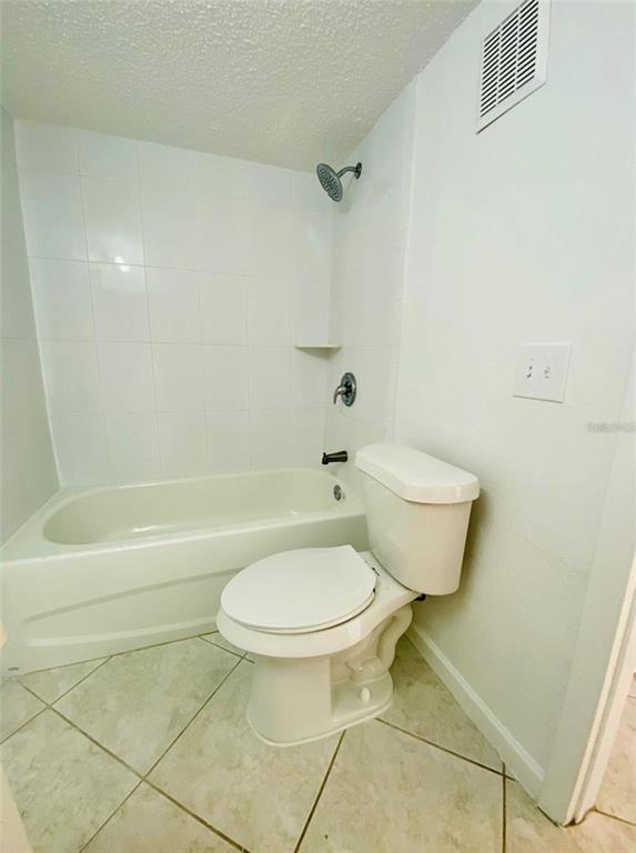 633 North Keene Road, Unit C Clearwater, FL 33755 - Photo 16 of 20 a white toilet sitting next to a bath tub and a shower