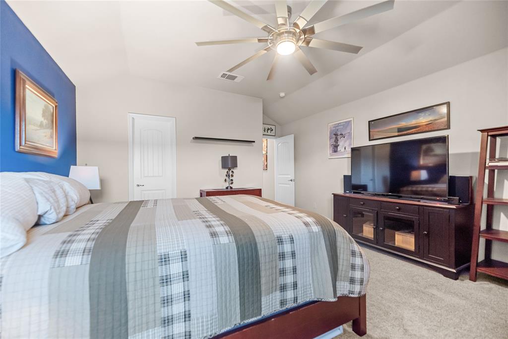 3616 Spring Run Lane Melissa, TX 75454 - Photo 11 of 23 a bedroom with a large bed and a flat screen tv