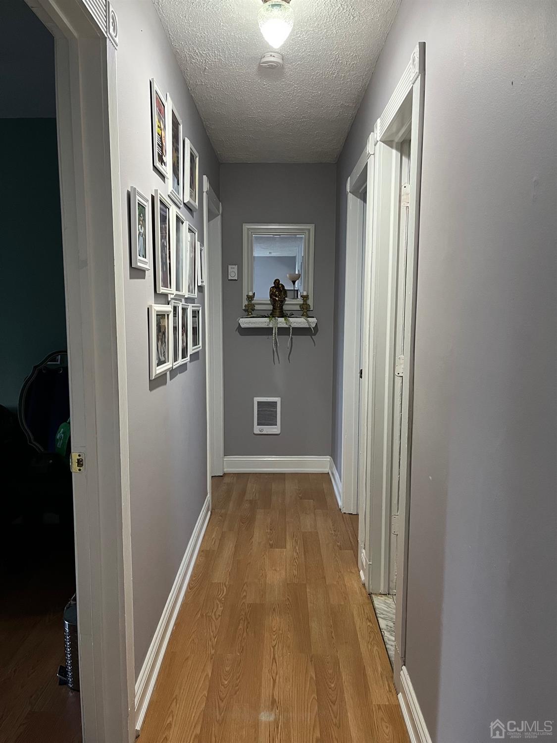 1 Brook Hollow Road Piscataway, NJ 08854 - Photo 16 of 18 a view of a hallway with wooden floor and a window
