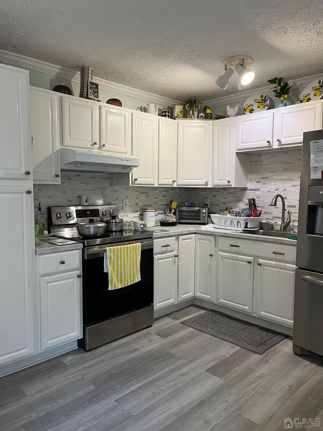 1 Brook Hollow Road Piscataway, NJ 08854 - Photo 17 of 18 a kitchen with granite countertop a sink cabinets and stainless steel appliances