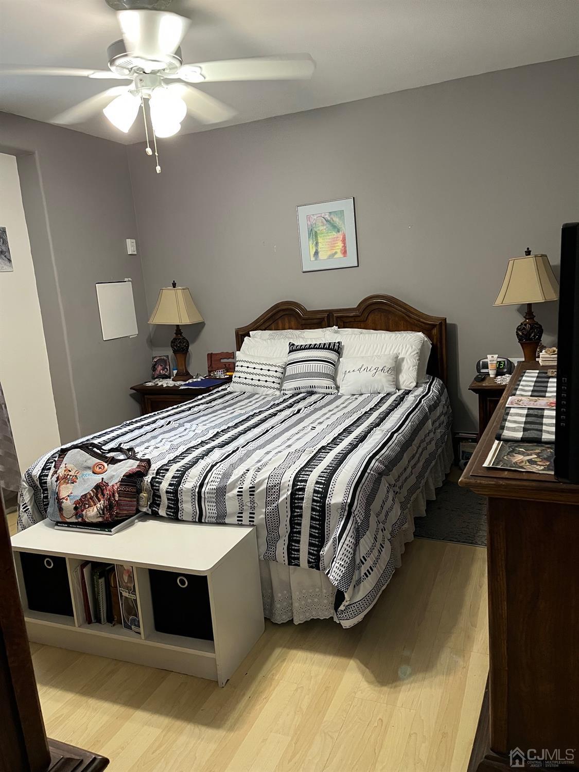 1 Brook Hollow Road Piscataway, NJ 08854 - Photo 8 of 18 a bedroom with a bed and a chandelier