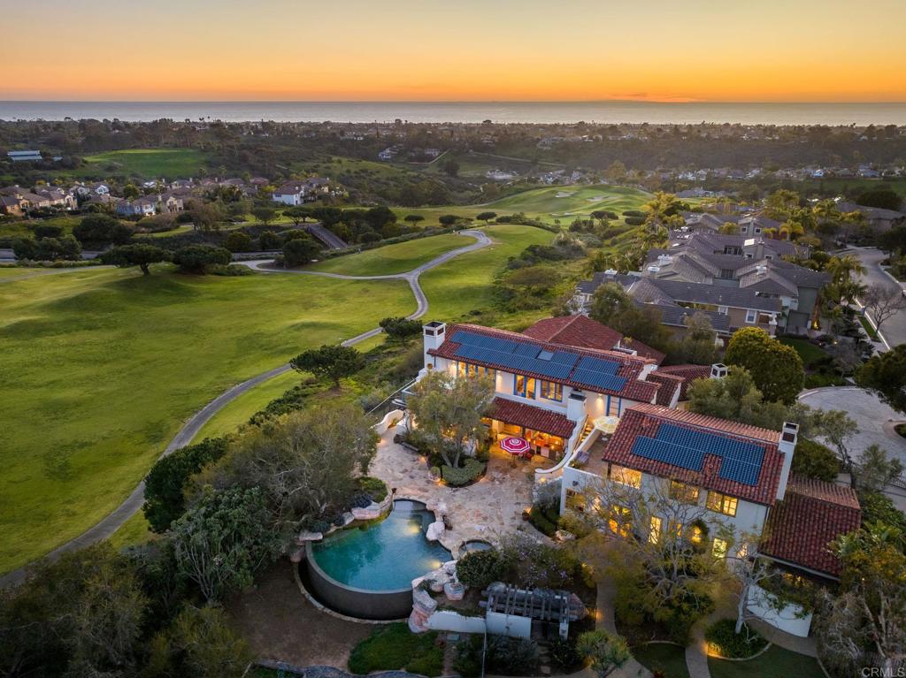 an aerial view of residential houses with outdoor space and river