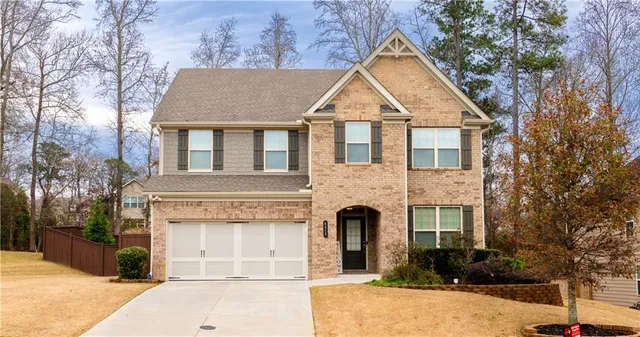 a front view of a house with a yard and garage