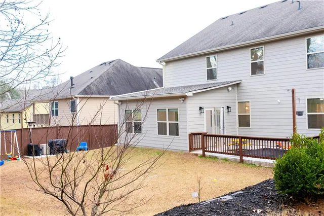 a view of a house with a yard and sitting area