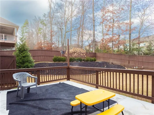 an empty room with windows and ceiling fan