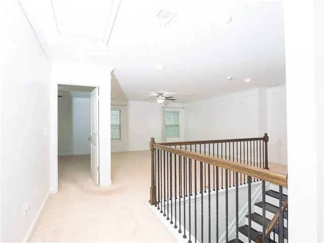 an empty room with windows and fireplace