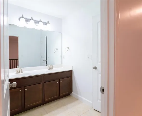 an empty room with closet and a chandelier fan