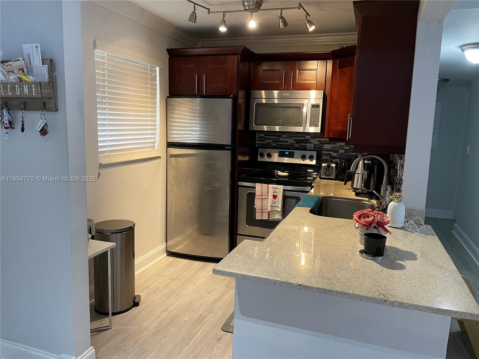 a kitchen with a refrigerator and a sink
