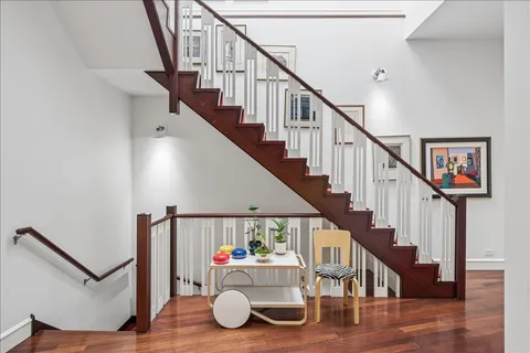 a view of entryway livingroom and hall with wooden floor