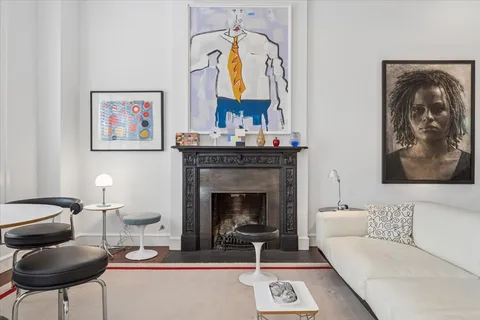 a living room with furniture a rug and a fireplace