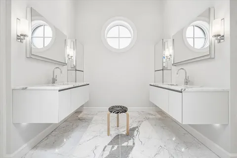 a bathroom with a sink mirror and vanity