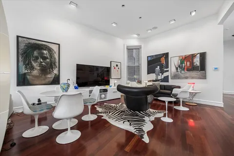 a living room with furniture a flat screen tv and kitchen view
