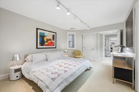 a bedroom with a bed and a couch