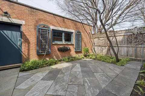 a backyard of a house with plants and trees
