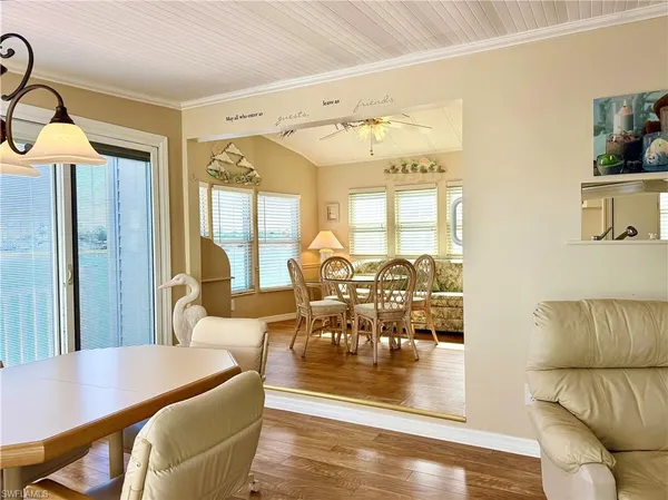 a view of a dining room with furniture wooden floor and a chandelier