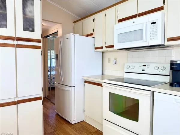 a kitchen with stainless steel appliances a refrigerator and a stove top oven