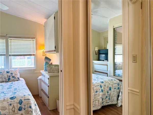 a bedroom with window and walk in closet